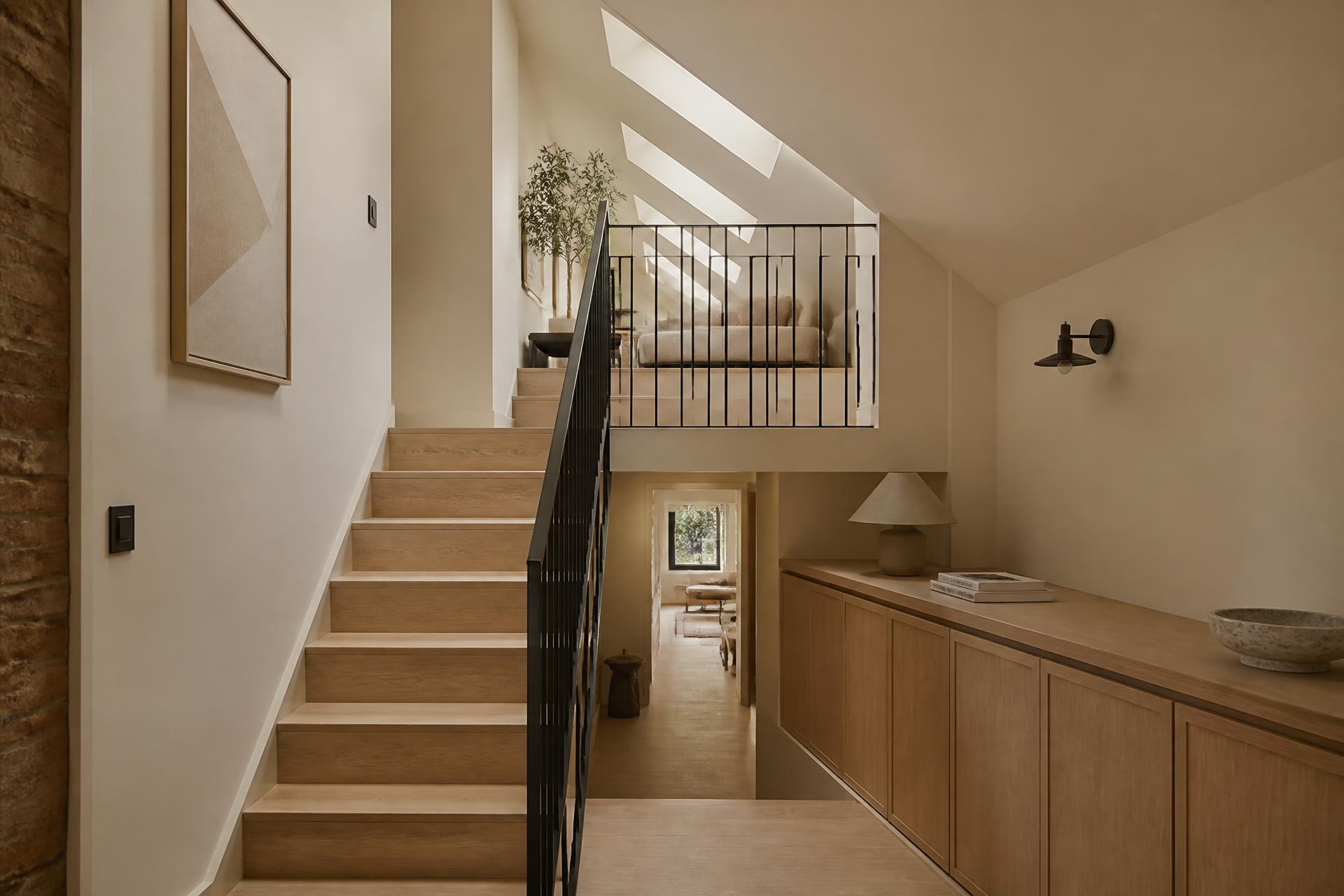 Luxury loft conversion interior with oak staircase and rooflights